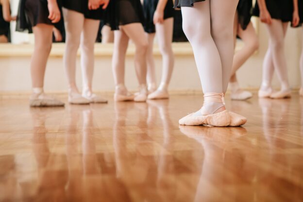 Little ballerinas doing exercises ballet class