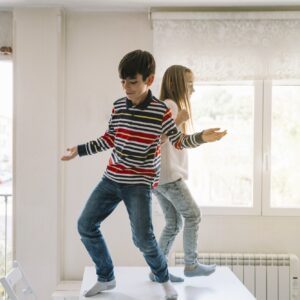 Two kids dancing on the table