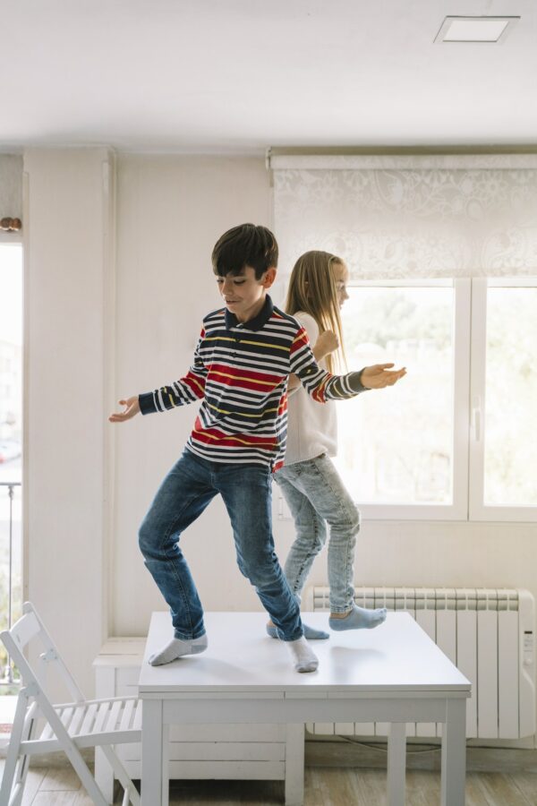 Two kids dancing on the table