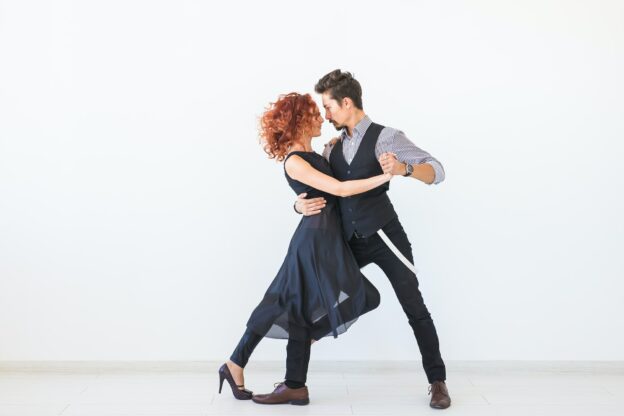 Social dance, kizomba, tango, salsa, people concept - beautiful couple dancing bachata on white